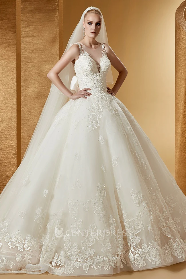 Feminine Cap Sleeve Ball Gown With Illusive Neckline And Back Bow